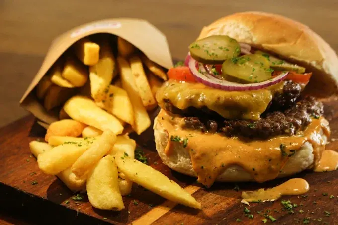 Burger and chips on a wooden board