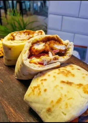 Cheekin strip wrap cut in half on a wooden board